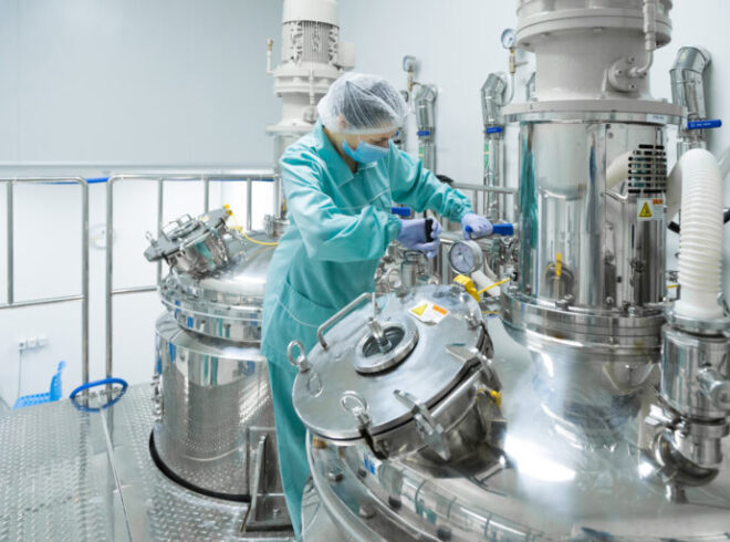 Pharmaceutical technician in sterile environment at pharmacy industry
